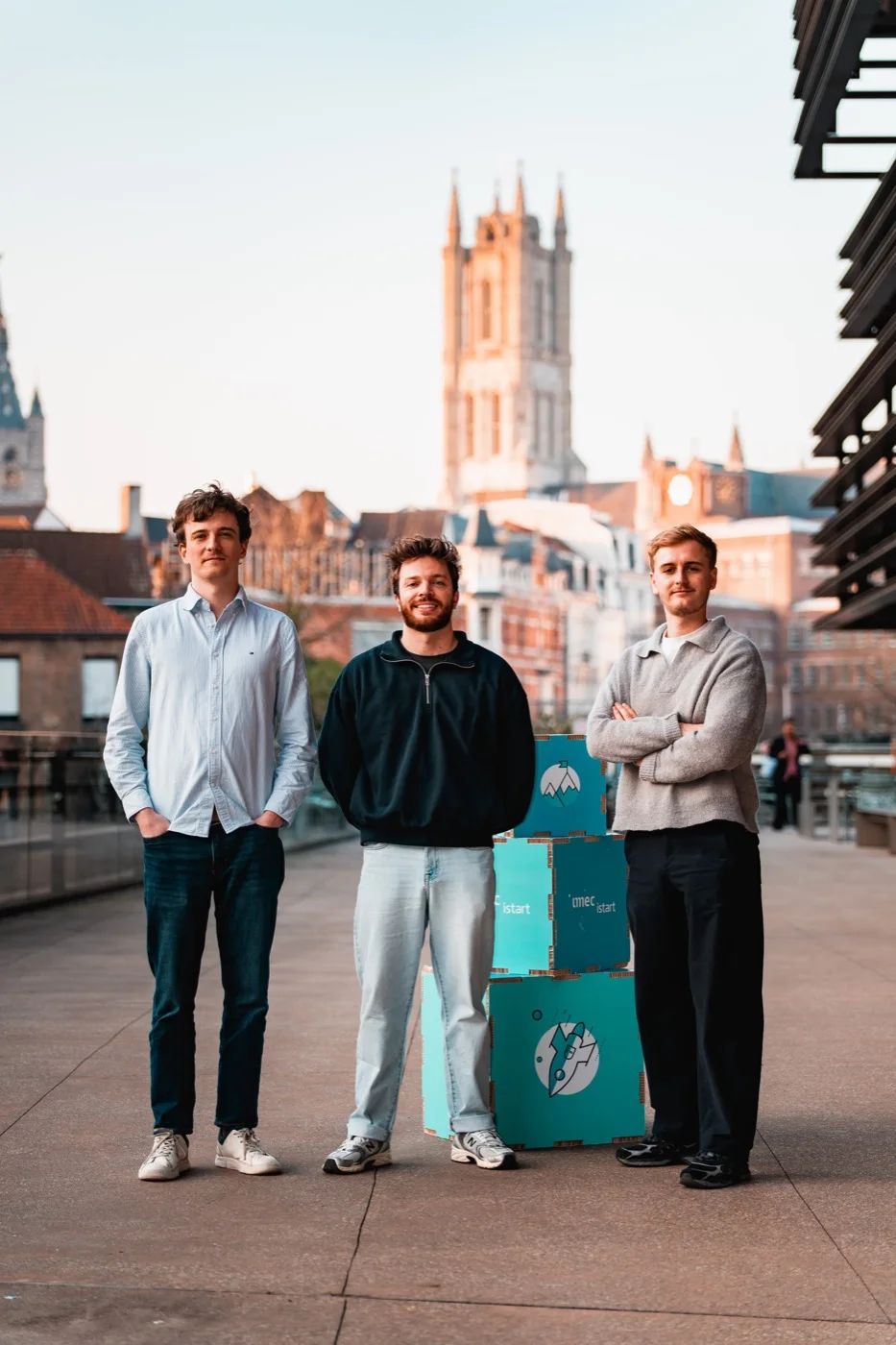 The three founders of Archer & Summit standing on a bridge in Brussels